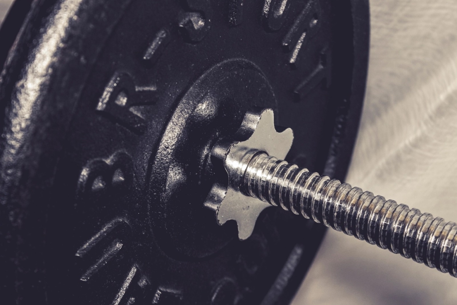 Close up of a loaded barbell sleeve and collar